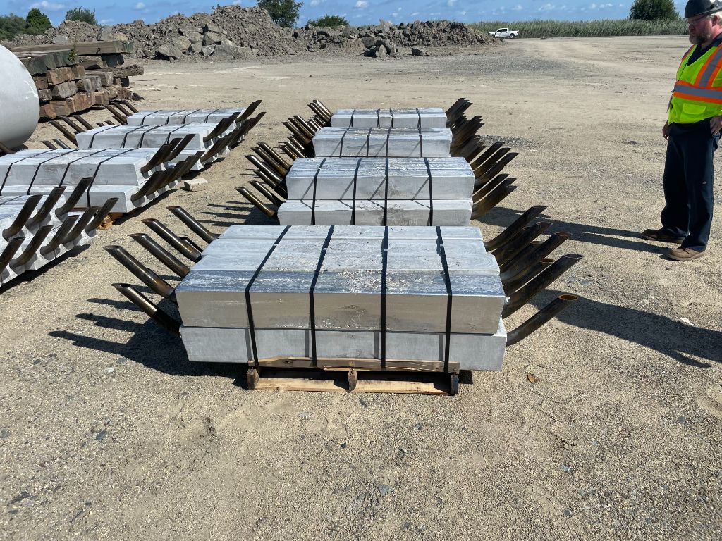 Aluminum anodes staged on-site for cathodic protection as part of structural steel repair services