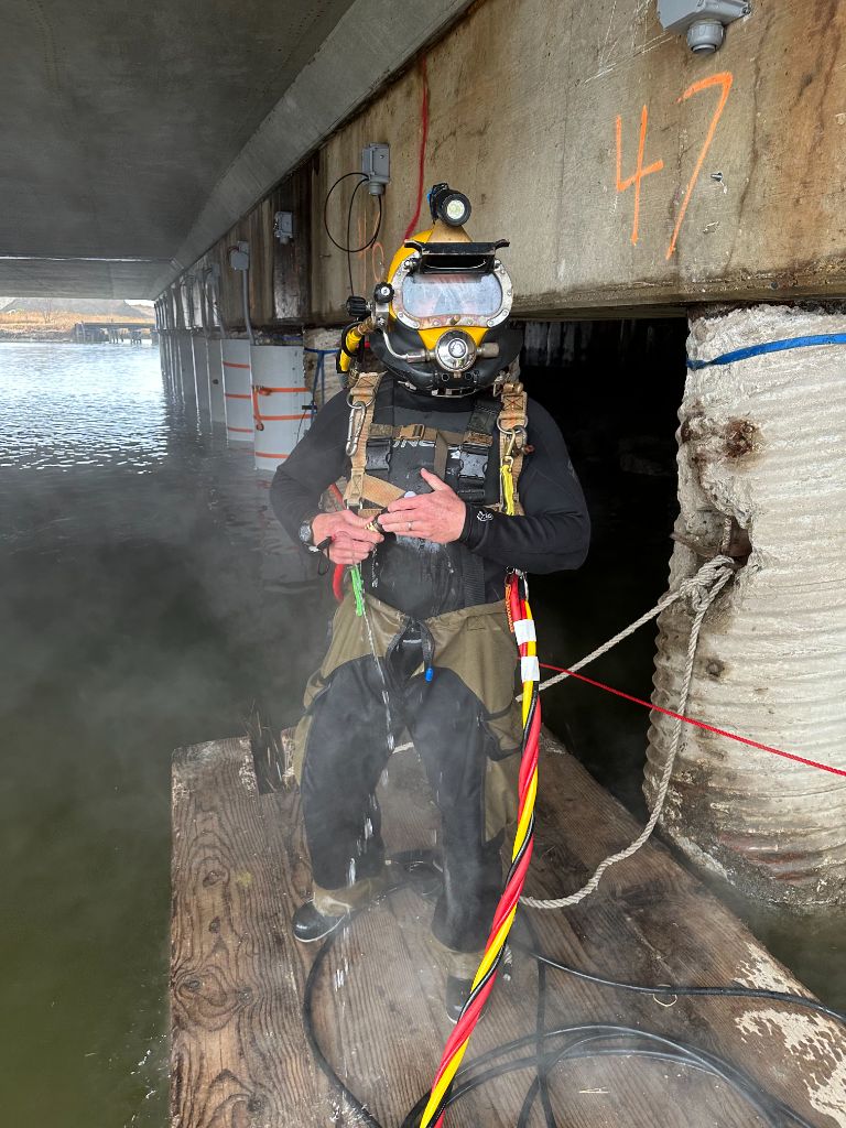 Diver performing concrete pile encasement on structural piling