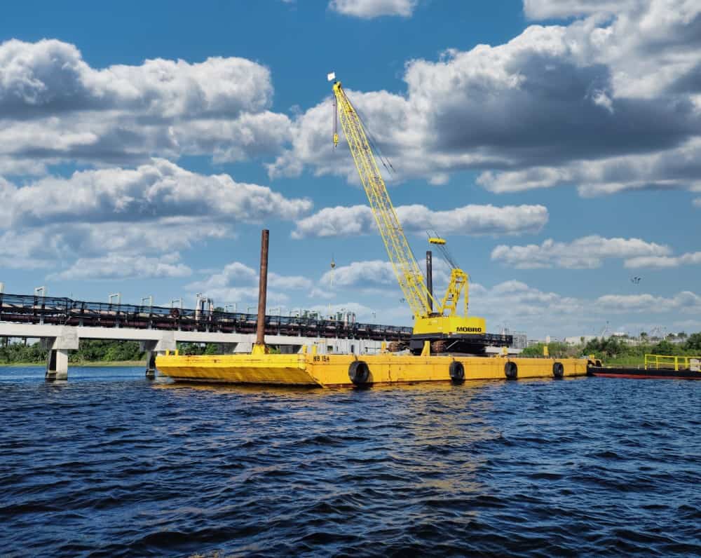 Marine construction crane barge at industrial waterfront