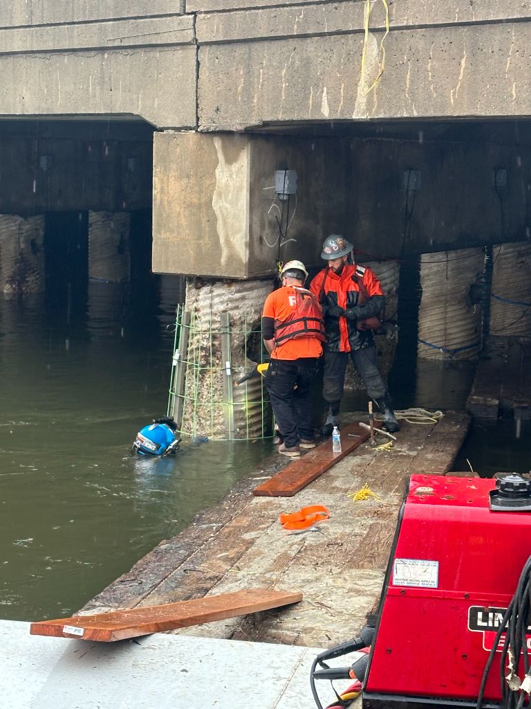SubCon diver and tenders installing a concrete pile encasement with rebar cage formwork on a bridge pier